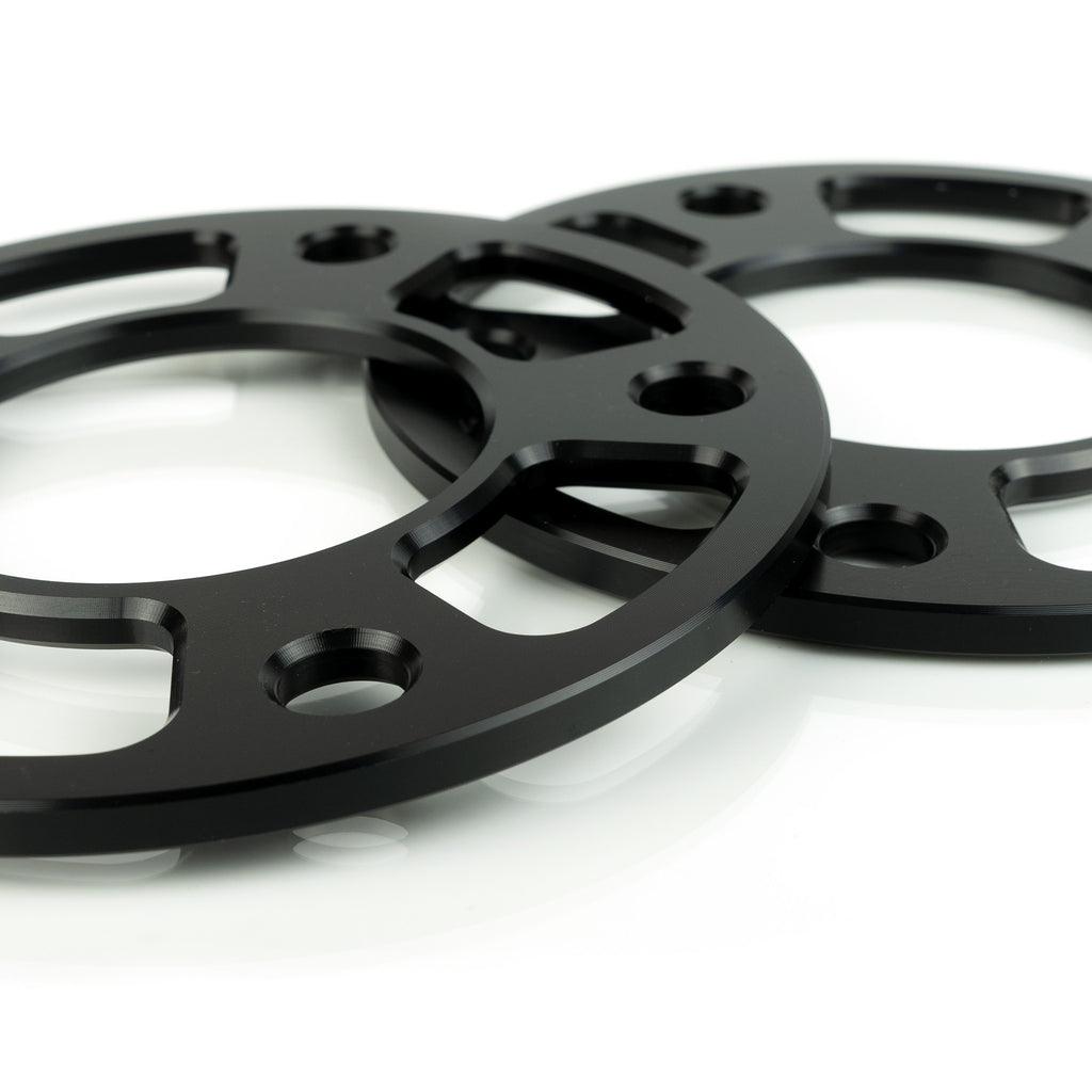 CNC machined AMT Corvette wheel spacers showing weight reduction pockets